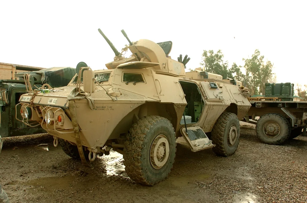 m1117 asv M1117 Guardian armored vehicle in desert camouflage with side door open.