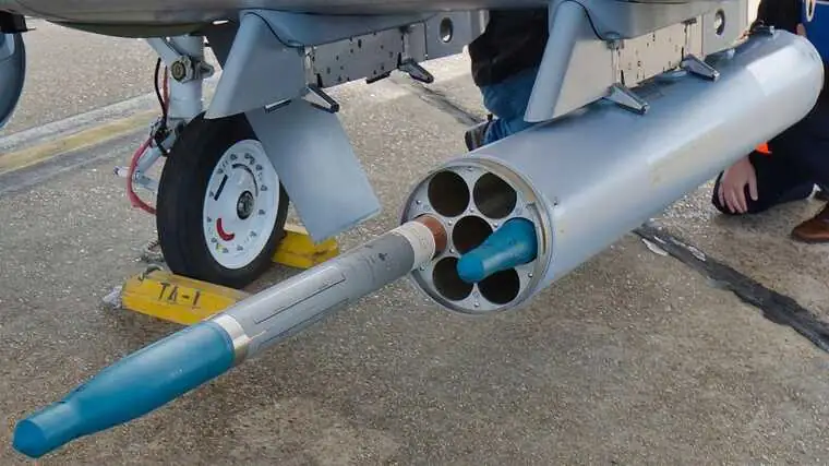 Marine assembling APKWS II rocket guidance section.