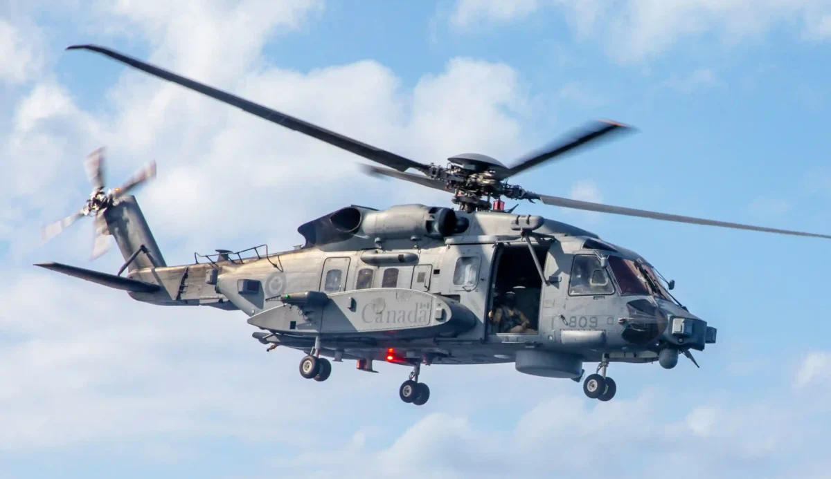 CH-148 Cyclone helicopter lifts off from a ship’s flight deck.