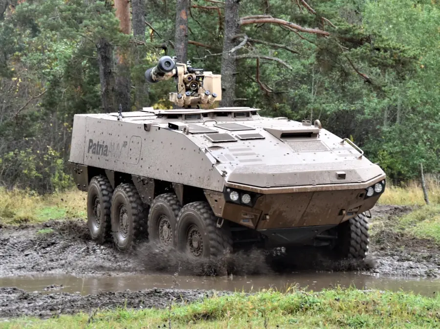 Patria AMV XP 8×8 moving through mud and water, showcasing high mobility in challenging terrain.