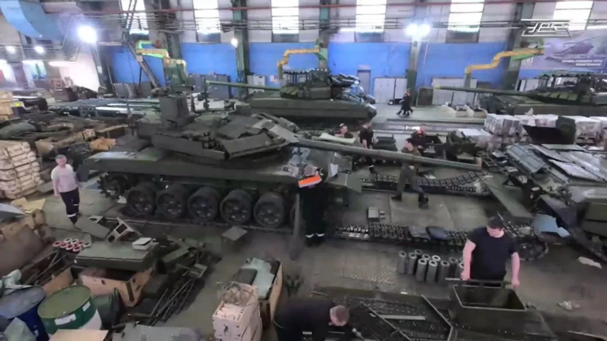  T-90 tank in green camouflage on battlefield.