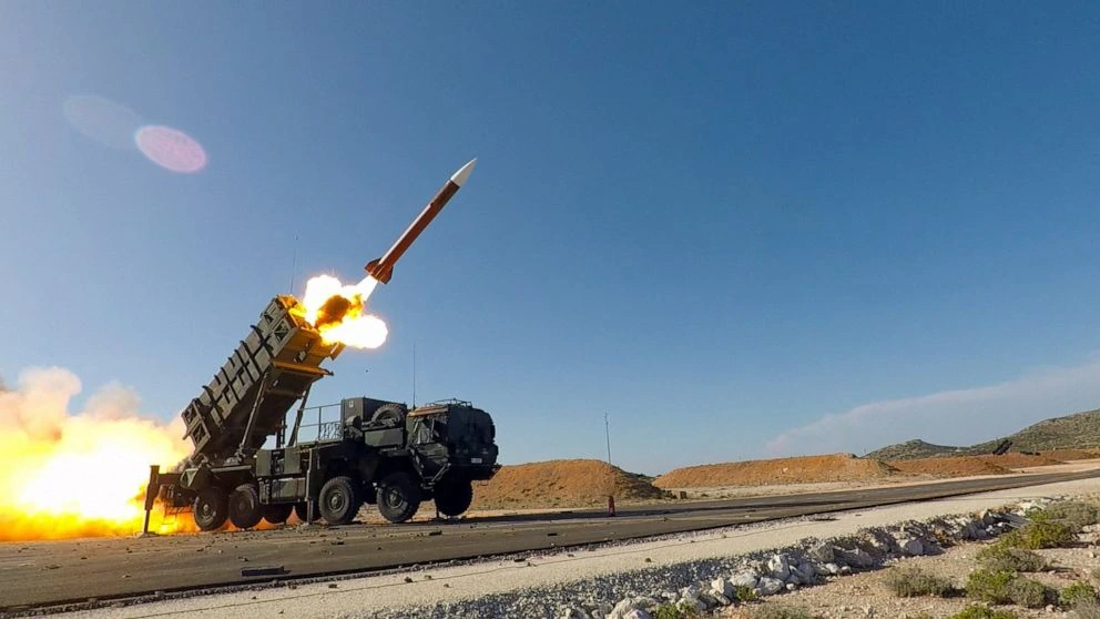 Patriot missile launching with smoke and flames.